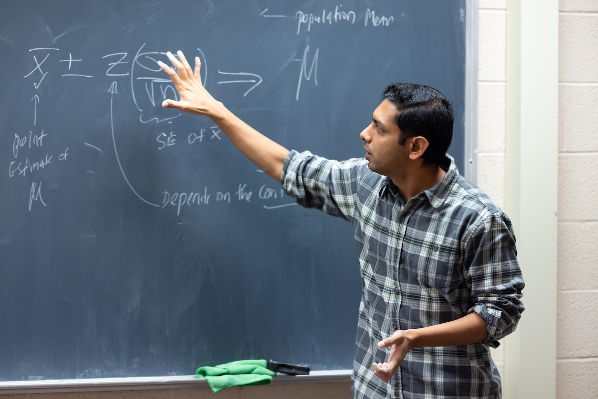instructor writing on chalkboard