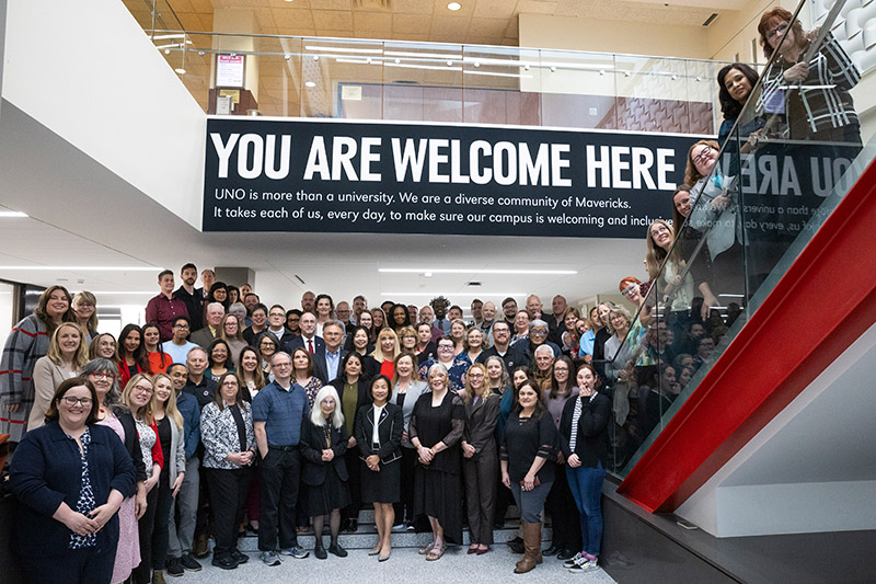 uno employees group together to take a picture to celebrate work anniversaries